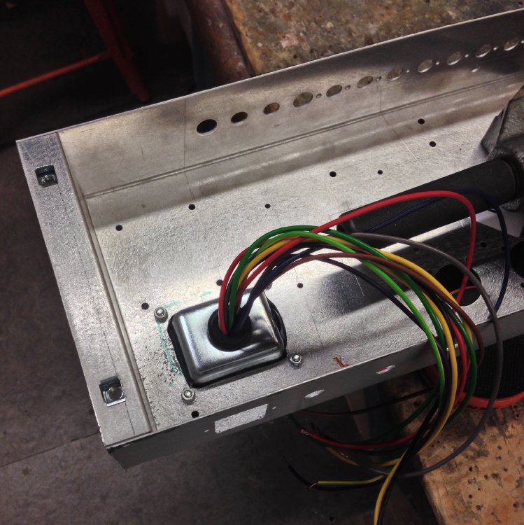 A view inside the amp's metal chassis, showing the hole for the power transformer with said transformer installed in place.