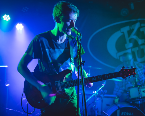 My brother on stage at King Tut's Wah Wah hut singing into a mic whilst holding a PRS guitar