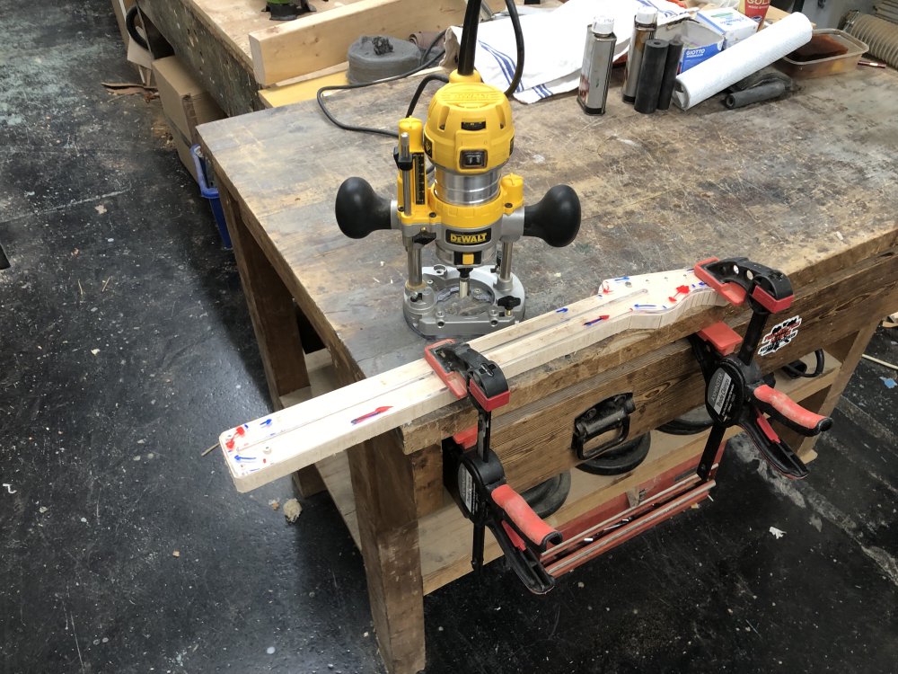 The rough neck with template sits clamped to a workbench, with the plunge-router sat next to it ready to go.