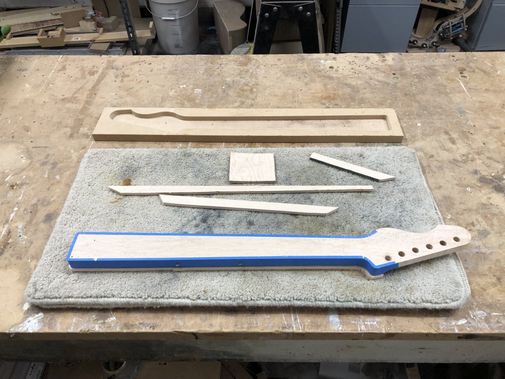 The same picture as before, only now the fretboard material only juts out from the neck by a few millimetres rather than being an unshaped plank.