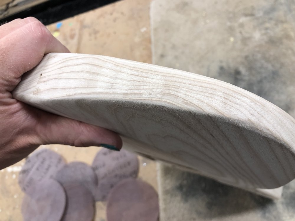 A photo of the side of the guitar body, and you can just make out that there are quite a few faint bands of scratches, indicating where earlier sanding hasn't reached.