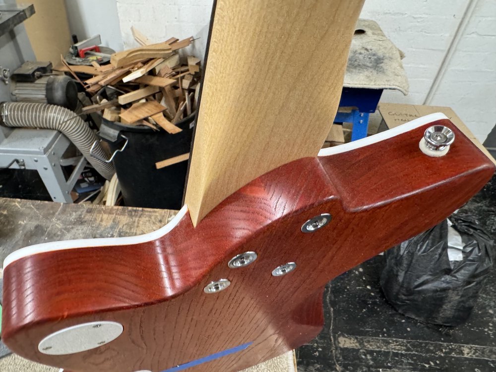 A close-up photo of the guitar assembled, showing where the neck joins the body. There is a nice clear line where the two meet.