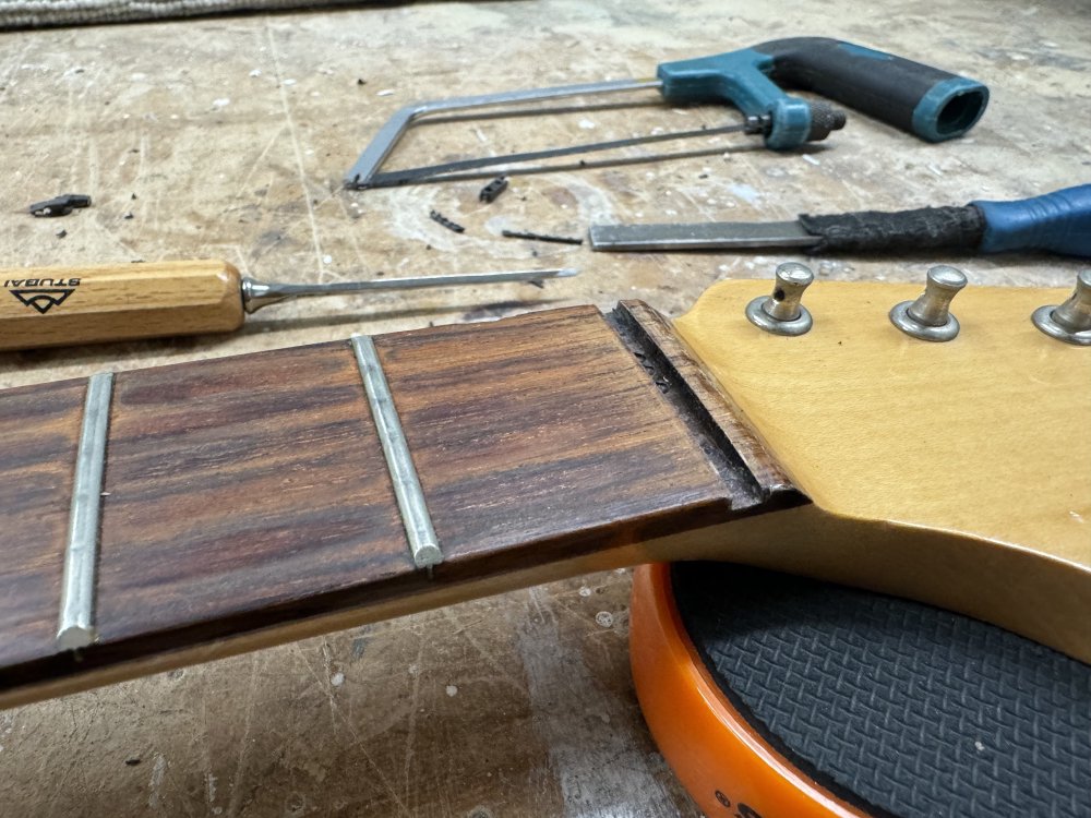 A photo of the rosewood fretboard on the old strat-clone neck, and there is now a perfectly clean slot where once there was a nut.