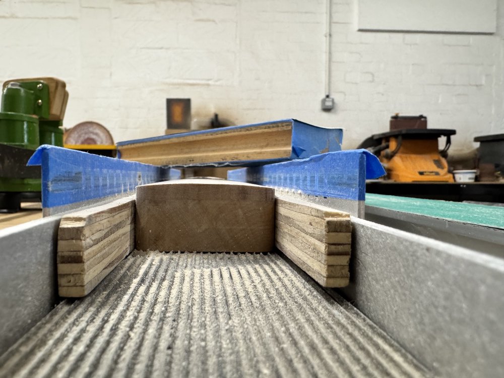 A photo taken from the heel end of the guitar neck in the jig, checking that the radius sanded into the neck is symmetric - it currently looks reasonably symmetric!
