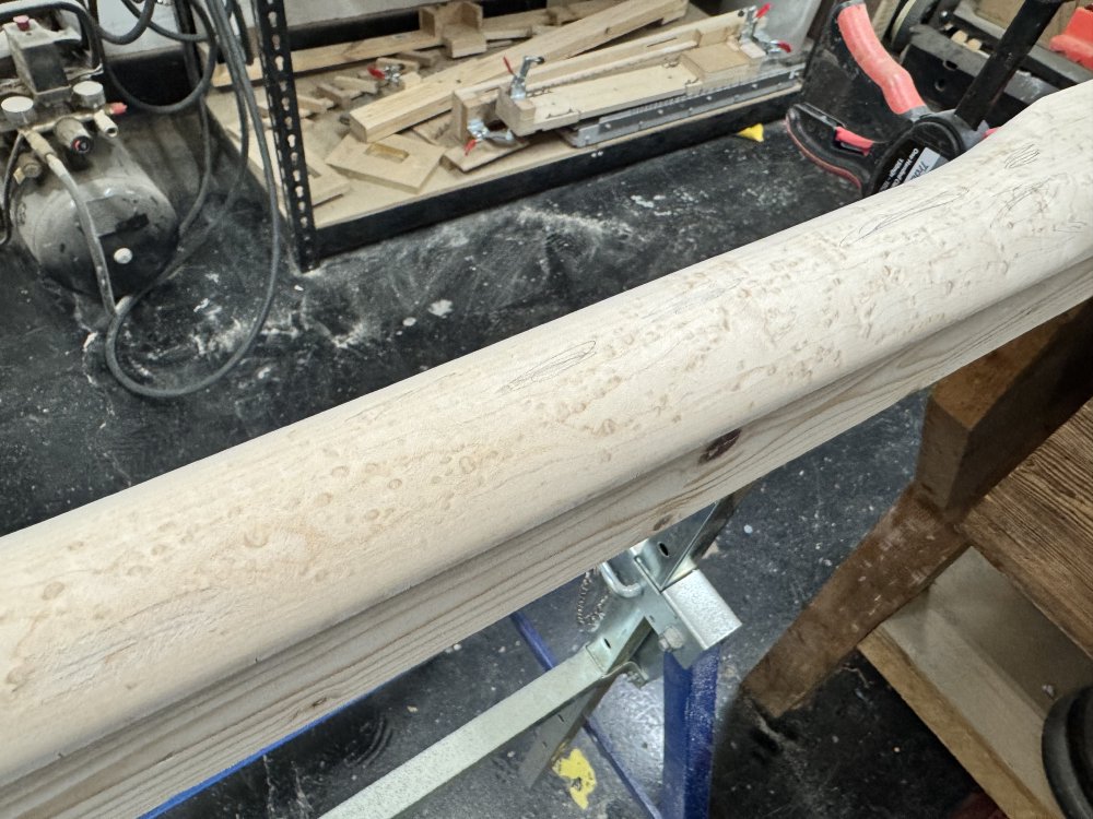 A close up photo showing what looks at a distance like a nicely smooth neck carge actually has a bunch of rasp scratches still on it, which have been marked out in pencil.
