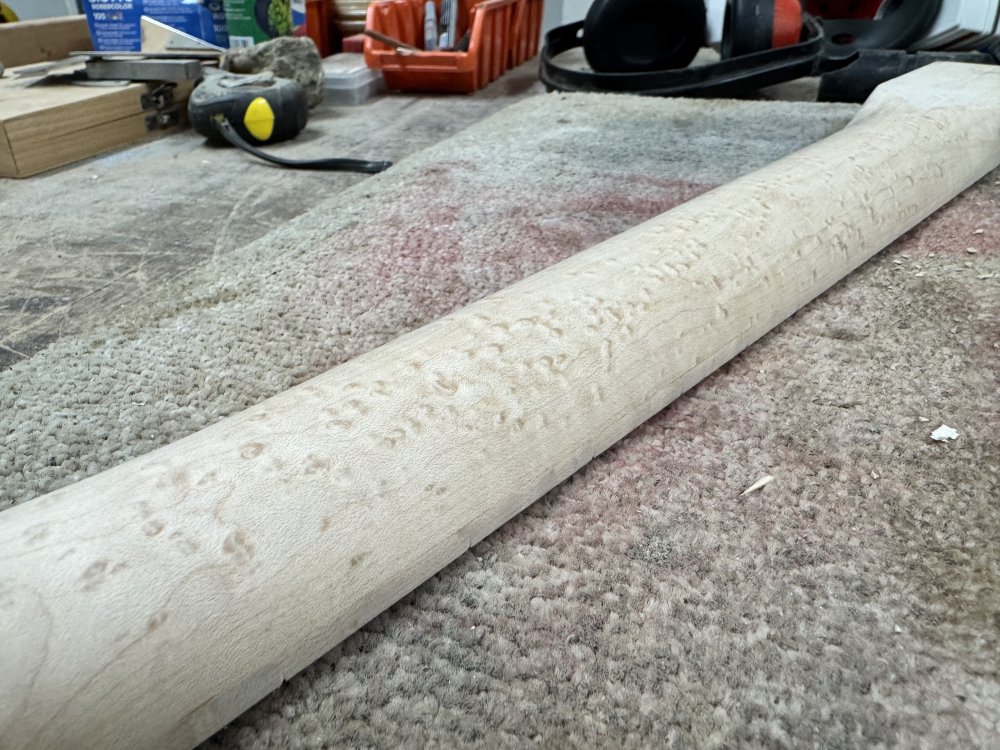 A close up photo of the middle of the newly carved neck, showing a smooth transition along its length.