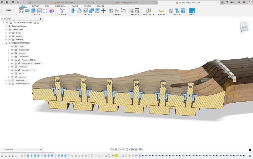 A screen-shot of a CAD model of a guitar neck, showing a cross-section view of the lined up tuners in the headstock. With the cross-section view you can see the holes for the tuners are not a uniform diameter all the way up, they step in the middle with the rear half being a smaller diameter than that at the front.